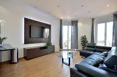 a living room with a couch and a flat screen tv at Très bel appartement centre-ville in Cannes