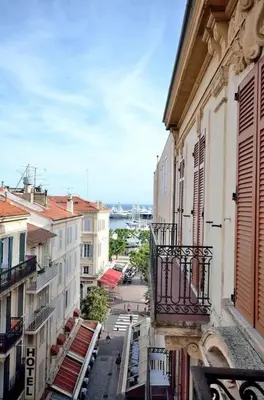 a view of a city street from a balcony at Très bel appartement centre-ville in Cannes