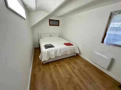 a bedroom with a bed in a white room at 2 Bedrooms appartement entièrement rénové Cannes - 200m de la plage in Cannes