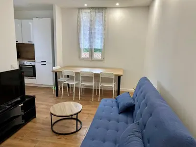 a living room with a blue couch and a table at 2 Bedrooms appartement entièrement rénové Cannes - 200m de la plage in Cannes