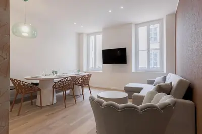 a living room with a couch and a table at 14 Vagliano - Palais, plage, clim, hyper-centre in Cannes