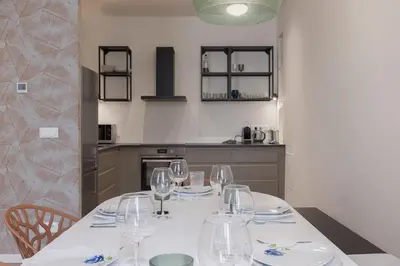 a kitchen with a table with wine glasses on it at 14 Vagliano - Palais, plage, clim, hyper-centre in Cannes