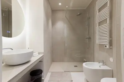 a white bathroom with a sink and a shower at 14 Vagliano - Palais, plage, clim, hyper-centre in Cannes