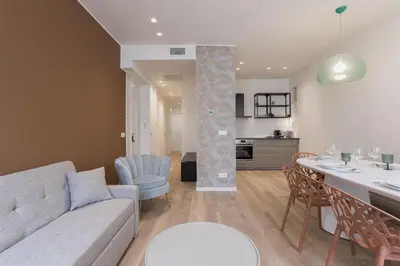a living room and kitchen with a couch and a table at 14 Vagliano - Palais, plage, clim, hyper-centre in Cannes
