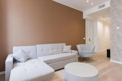 a living room with a couch and a chair at 14 Vagliano - Palais, plage, clim, hyper-centre in Cannes