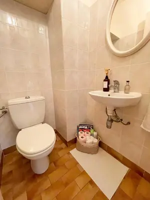a bathroom with a toilet and a sink at appartement avec piscine in Le Cannet