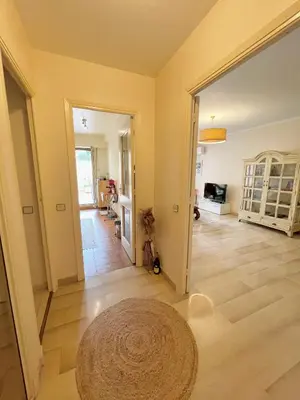 a living room with a rug on the floor at appartement avec piscine in Le Cannet