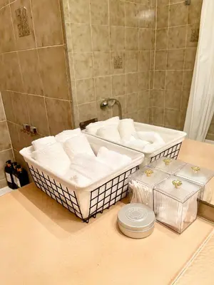 a bathroom with two baskets of towels and a tub at appartement avec piscine in Le Cannet