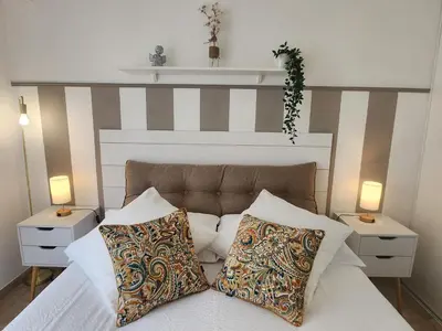 a bedroom with a bed with two night stands and two lamps at Cannes Paradis in Cannes
