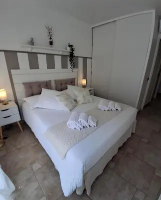 a bedroom with a large white bed with towels on it at Cannes Paradis in Cannes
