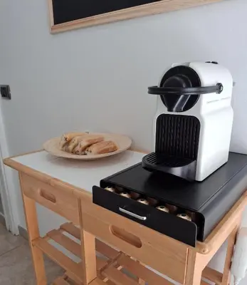 a kitchen counter with a toaster and a plate of food at Cannes Paradis in Cannes