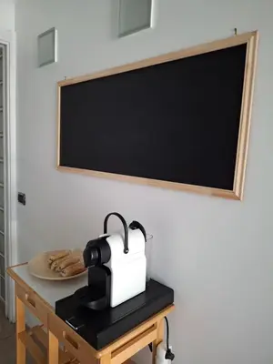 a table with a coffee maker and a blackboard at Cannes Paradis in Cannes