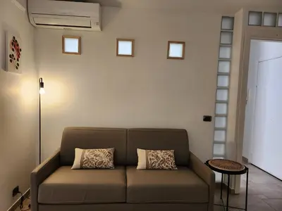 a couch in a living room with a wall with windows at Cannes Paradis in Cannes