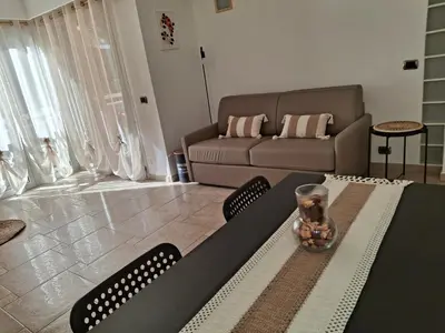 a living room with a table and a couch at Cannes Paradis in Cannes