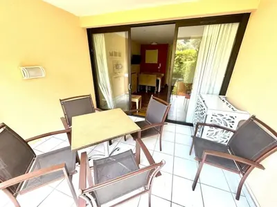 a patio with a table and chairs on a balcony at 4 people with Pool Tennis Parking air cond in Cannes