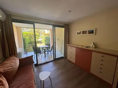 a living room with a couch and a table at 4 people with Pool Tennis Parking air cond in Cannes