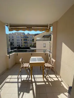 a table and two chairs on a balcony at Modern Apartment in Cannes in Cannes