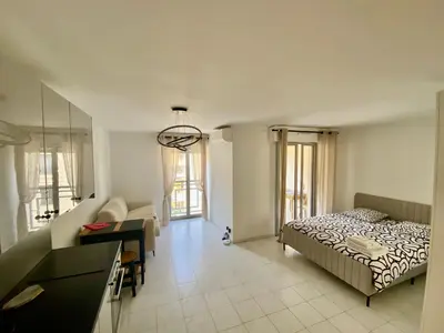 a bedroom with a bed and a desk at Modern Apartment in Cannes in Cannes