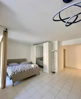a bedroom with a bed and a chandelier at Modern Apartment in Cannes in Cannes
