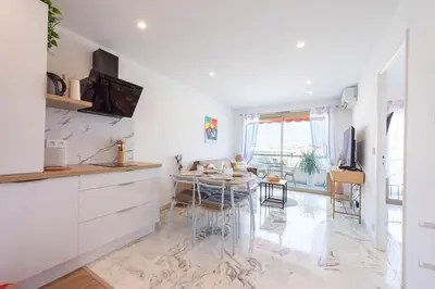 a kitchen with a table and a dining room at 1-Br Renovated Near Croisette in Cannes