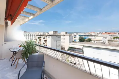 a balcony with a table and chairs and a view at 1-Br Renovated Near Croisette in Cannes