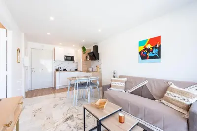 a living room with a couch and a table at 1-Br Renovated Near Croisette in Cannes