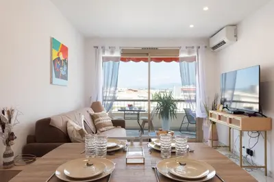 a living room with a couch and a table at 1-Br Renovated Near Croisette in Cannes