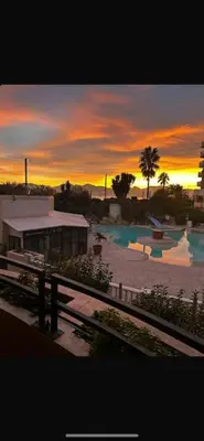 a sunset over a swimming pool in a resort at Appartement Cannes, Piscine - vue mer - terasse in Cannes