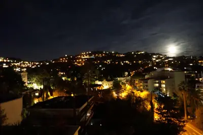 a view of a city at night with the moon at Best of the best in Cannes with a beautiful view in Cannes