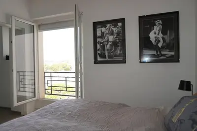 a bedroom with a bed and two pictures on the wall at Best of the best in Cannes with a beautiful view in Cannes