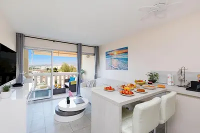 a living room with a table with food on it at ON VACAY - Votre havre de paix à 100 m des plages in Cannes