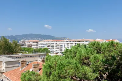 a view of a city with buildings and trees at ON VACAY - Votre havre de paix à 100 m des plages in Cannes