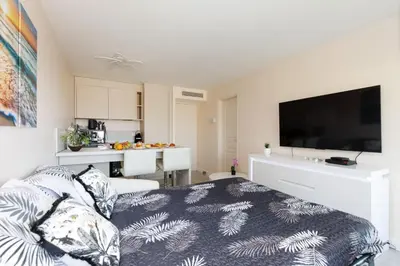 a living room with a bed and a kitchen at ON VACAY - Votre havre de paix à 100 m des plages in Cannes