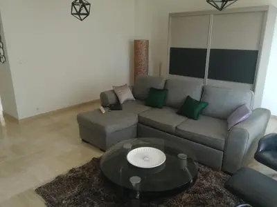 a living room with a couch and a table at Appartement cannes in Le Cannet
