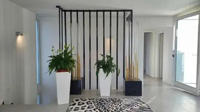 a hallway with two potted plants in a building at Villa MARGARITTA 4km Cannes centre et plages in Le Cannet