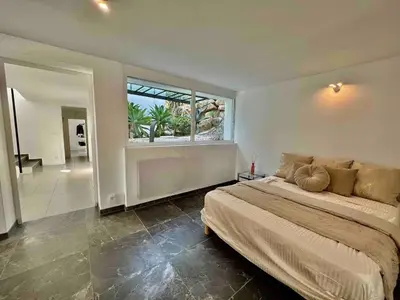 a bedroom with a large bed and a large window at Villa MARGARITTA 4km Cannes centre et plages in Le Cannet