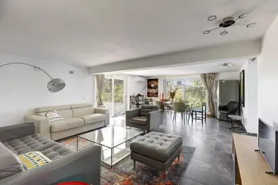 a living room with couches and a dining room at Villa MARGARITTA 4km Cannes centre et plages in Le Cannet
