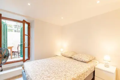 a bedroom with a bed and a window at La Suquétane - Appt proche plage Cannes in Cannes
