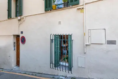 a window with a gate on the side of a building at La Suquétane - Appt proche plage Cannes in Cannes