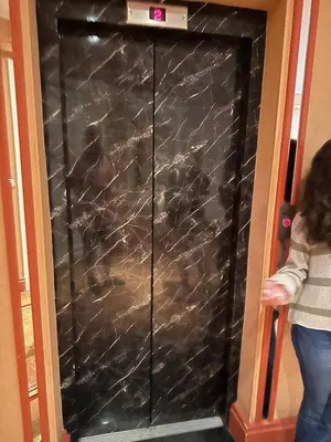 a woman is standing in front of a black wall at Cannes Croisette Miramar escape in Cannes
