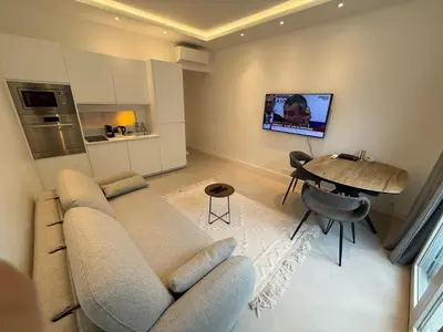 a living room with a couch and a table at Cannes Croisette Miramar escape in Cannes