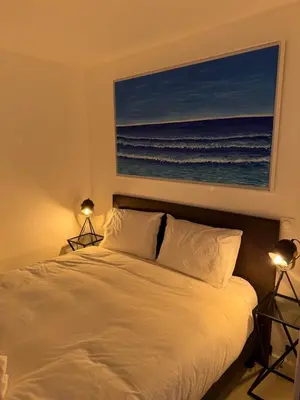 a bedroom with a bed with a picture of the ocean at Cannes Croisette Miramar escape in Cannes