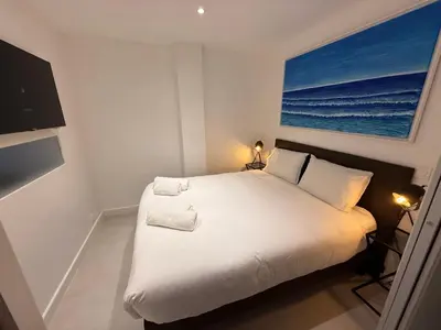 a bedroom with a bed with a picture of the ocean at Cannes Croisette Miramar escape in Cannes