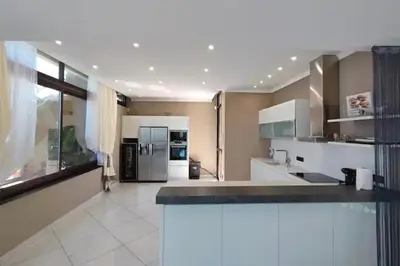 a large kitchen with stainless steel appliances at Villa Emilia, vue mer, Super-Cannes in Vallauris