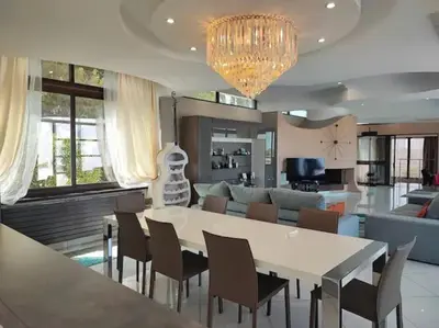 a living room with a large white table and chairs at Villa Emilia, vue mer, Super-Cannes in Vallauris