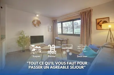 a living room with a couch and a table at Fil - Piscine - 2 min Mer - VCA in Cannes