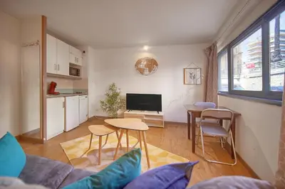 a living room with a couch and a table at Fil - Piscine - 2 min Mer - VCA in Cannes