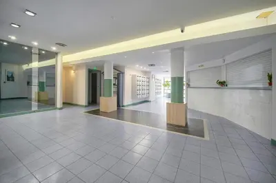 a hallway of a building with columns and a lobby at Fil - Piscine - 2 min Mer - VCA in Cannes