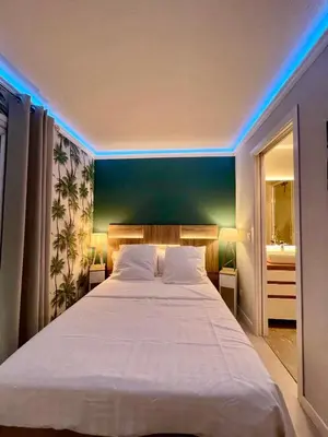 a bedroom with a large white bed with blue lights at Azuria in Cannes
