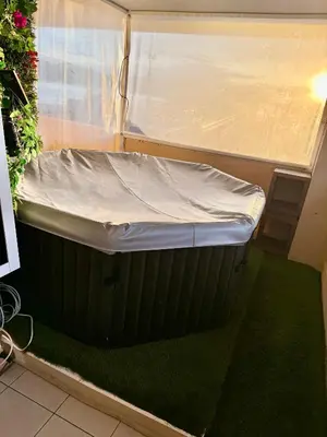 a small bed in a room with green carpet at Azuria in Cannes